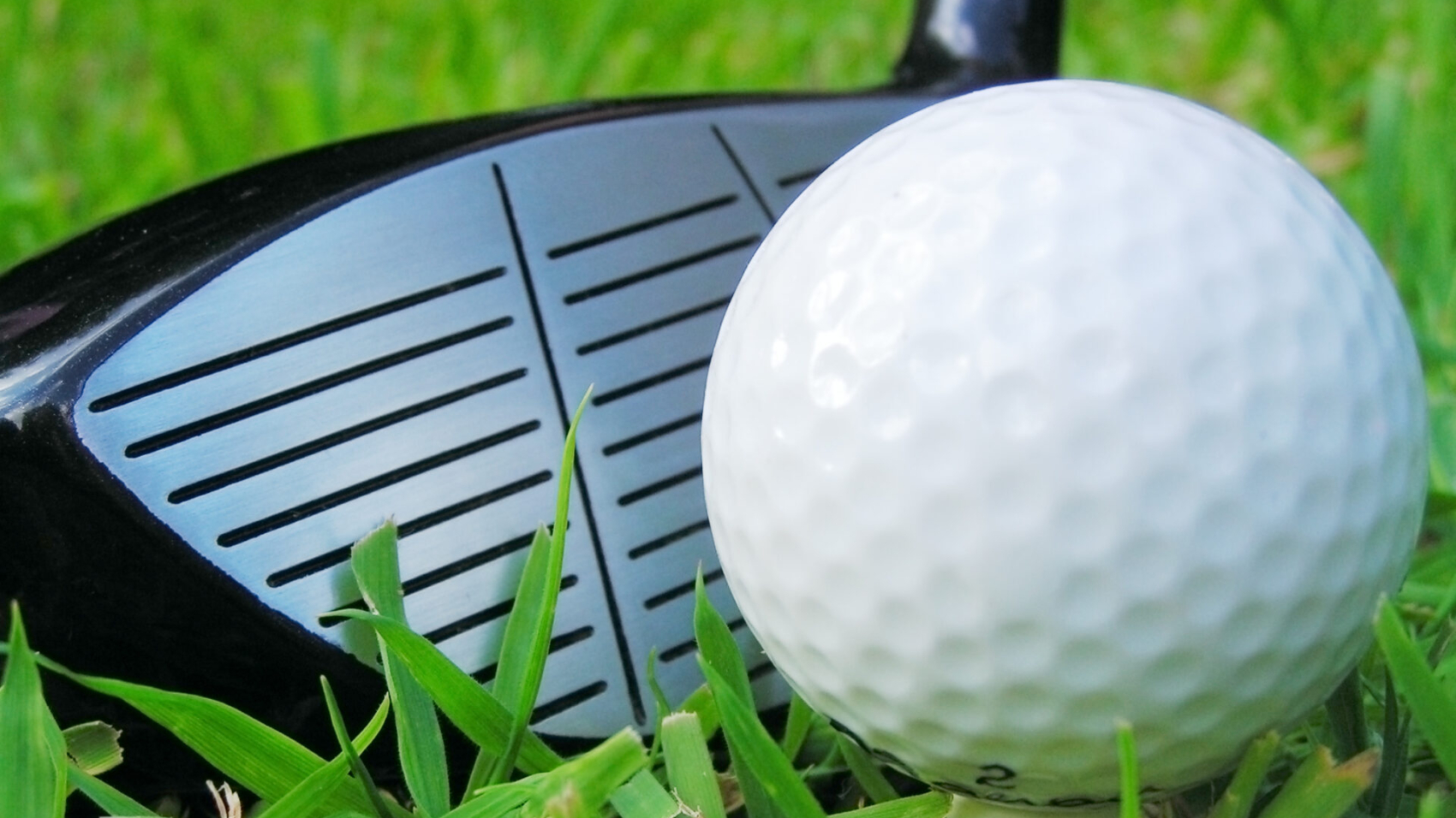 Golf ball on tee with club